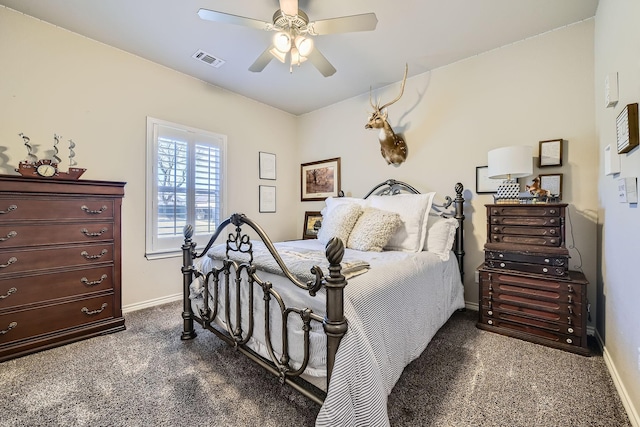 bedroom featuring dark colored carpet, visible vents, ceiling fan, and baseboards