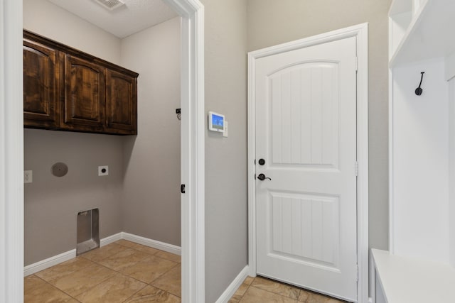 clothes washing area with cabinet space, baseboards, and electric dryer hookup