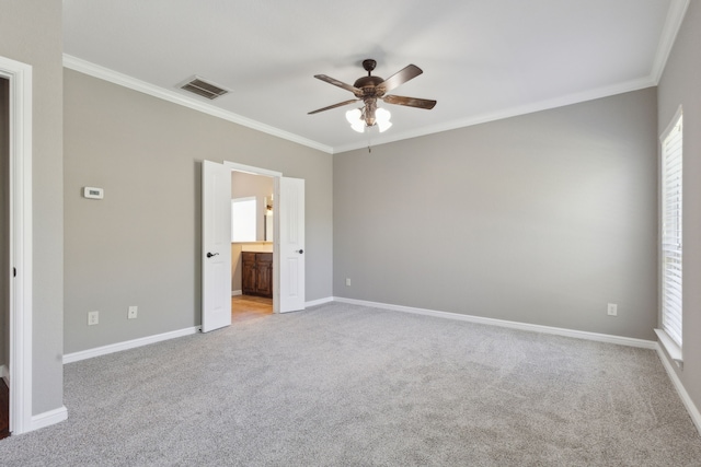 unfurnished bedroom featuring ornamental molding, light colored carpet, and visible vents