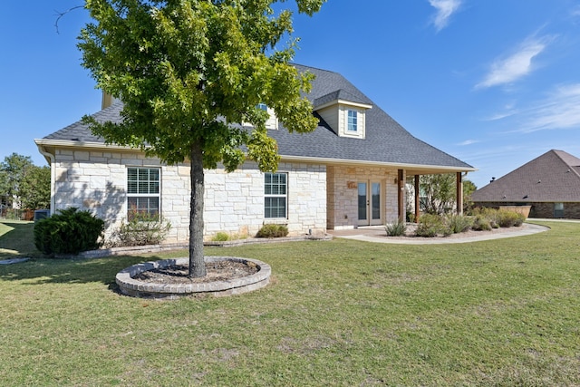 view of front of home featuring stone siding, a shingled roof, and a front lawn