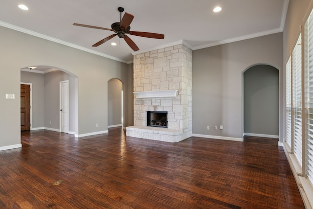 unfurnished living room with recessed lighting, a fireplace, wood finished floors, baseboards, and ornamental molding