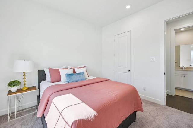 bedroom with light carpet, recessed lighting, connected bathroom, and baseboards