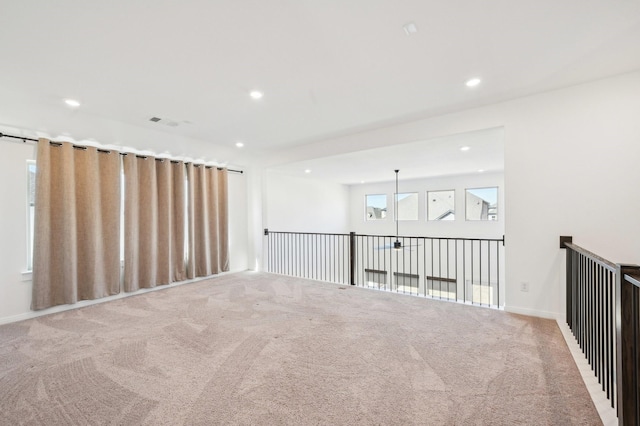 spare room with carpet, visible vents, baseboards, and recessed lighting