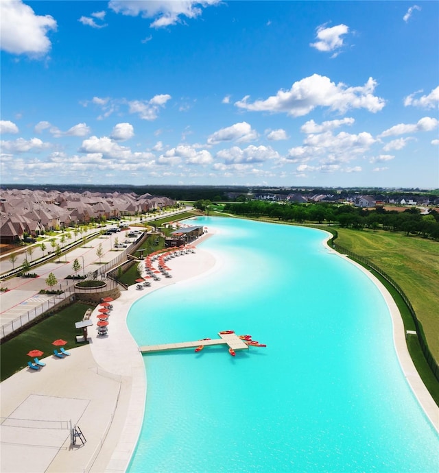 view of pool featuring a water view and a residential view