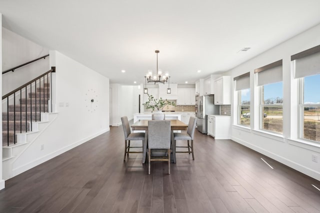 dining space with baseboards, dark wood-style flooring, stairway, and a notable chandelier