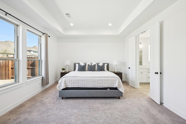 bedroom with light carpet, baseboards, a tray ceiling, and recessed lighting