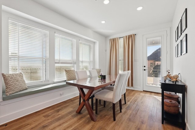 dining room with recessed lighting, wood finished floors, and baseboards