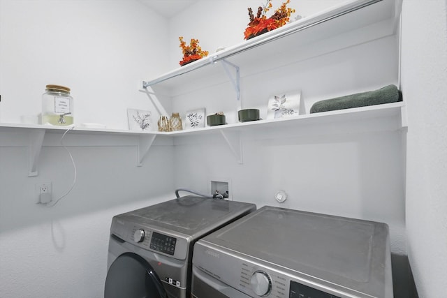 laundry area featuring washing machine and clothes dryer and laundry area