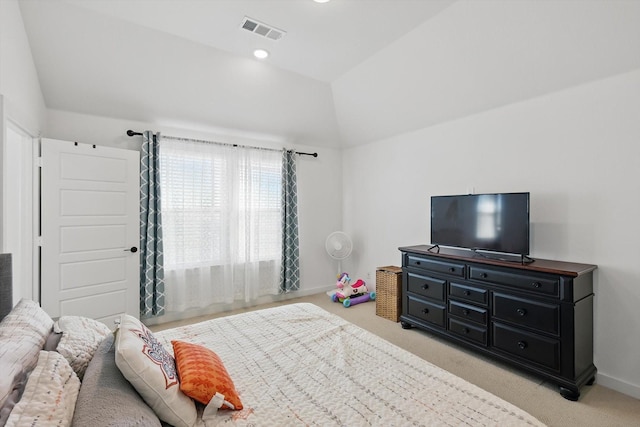 bedroom with light colored carpet, vaulted ceiling, visible vents, and baseboards