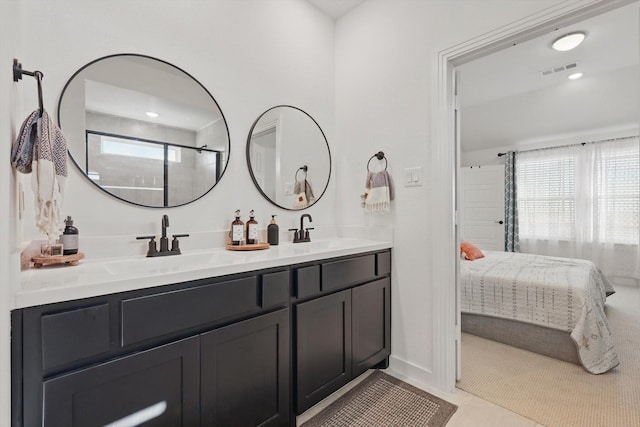bathroom featuring double vanity, visible vents, connected bathroom, and a sink