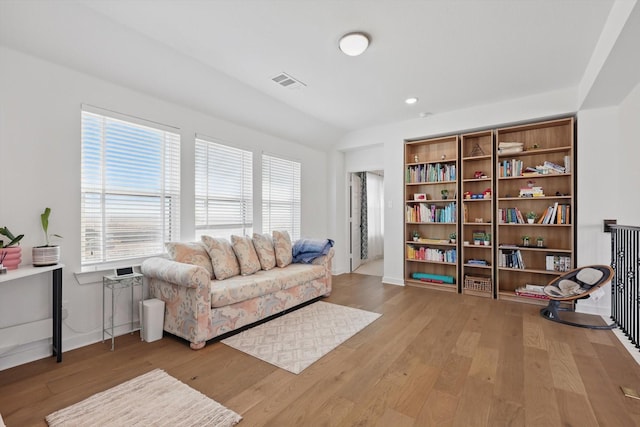 sitting room featuring baseboards, a healthy amount of sunlight, wood finished floors, and visible vents