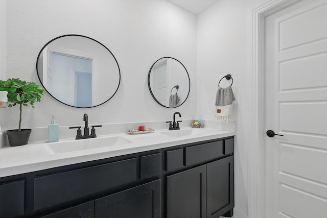 bathroom featuring a sink and double vanity