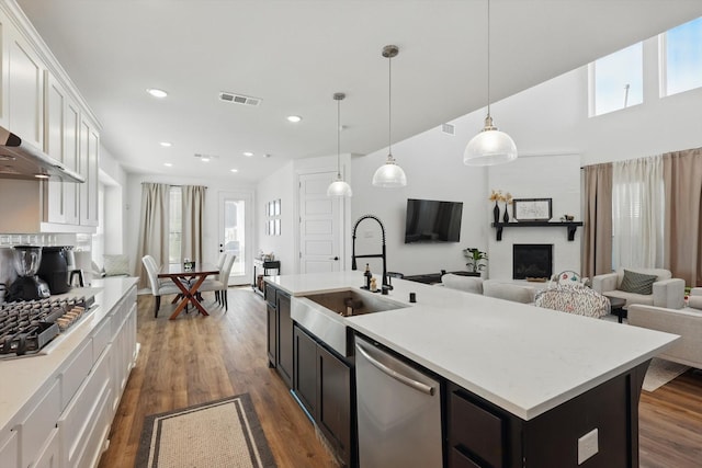 kitchen featuring white cabinets, a wealth of natural light, stainless steel appliances, and a sink