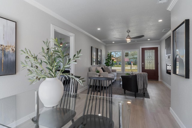 interior space featuring ornamental molding, wood finished floors, and baseboards