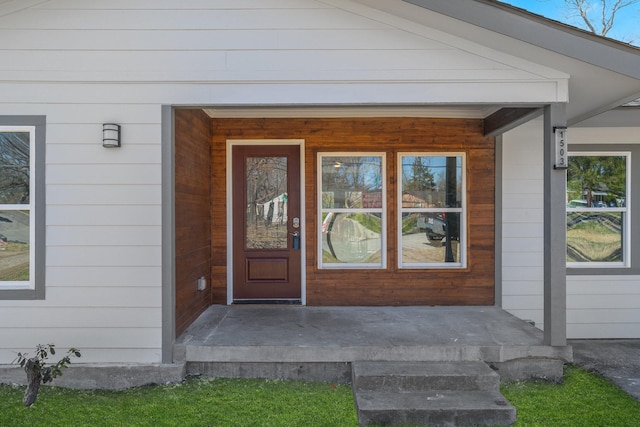 view of exterior entry with covered porch