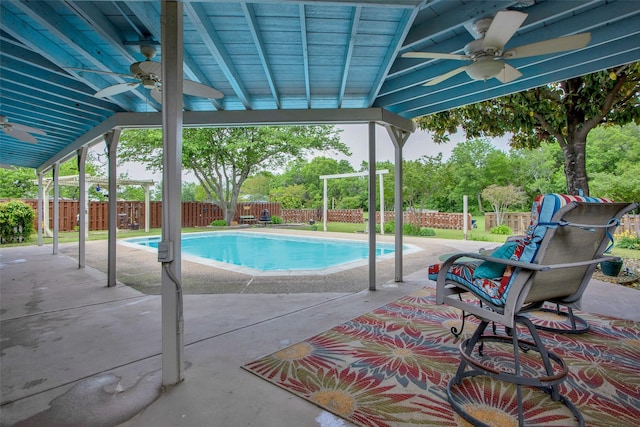 view of pool with a ceiling fan, a fenced in pool, a fenced backyard, and a patio