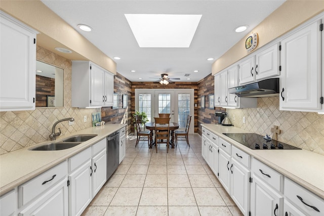 kitchen with light countertops, a sink, black electric cooktop, and under cabinet range hood