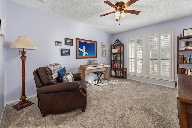 sitting room featuring carpet flooring, ceiling fan, a textured ceiling, and baseboards