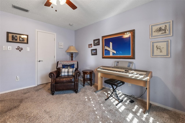 office space featuring baseboards, visible vents, ceiling fan, a textured ceiling, and carpet floors