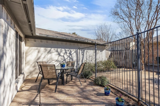 wooden terrace featuring outdoor dining space and fence