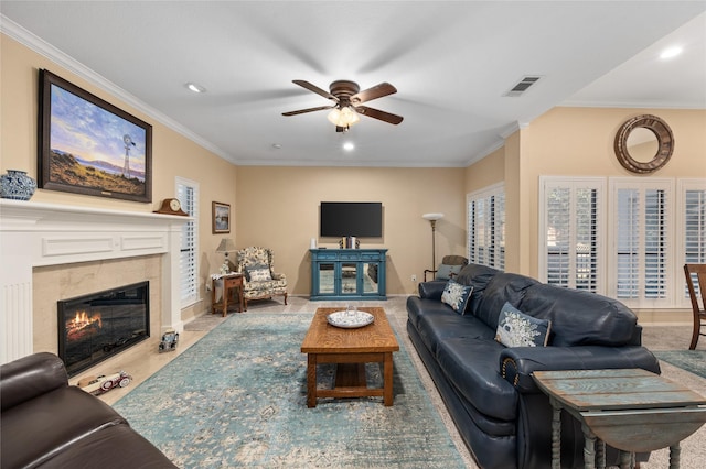 living area featuring recessed lighting, visible vents, crown molding, and a high end fireplace