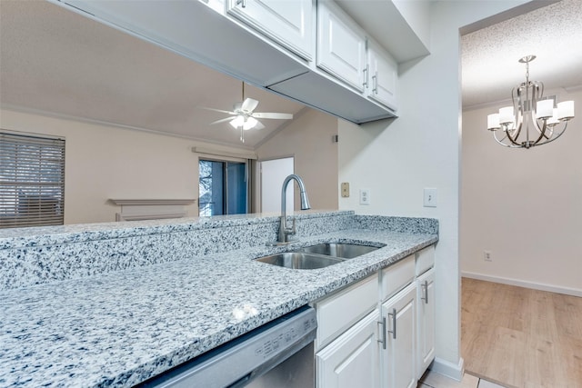 kitchen with light wood-style flooring, light stone counters, white cabinetry, a sink, and ceiling fan with notable chandelier