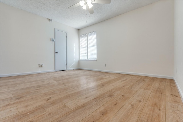 empty room featuring light wood-style floors, a textured ceiling, baseboards, and a ceiling fan