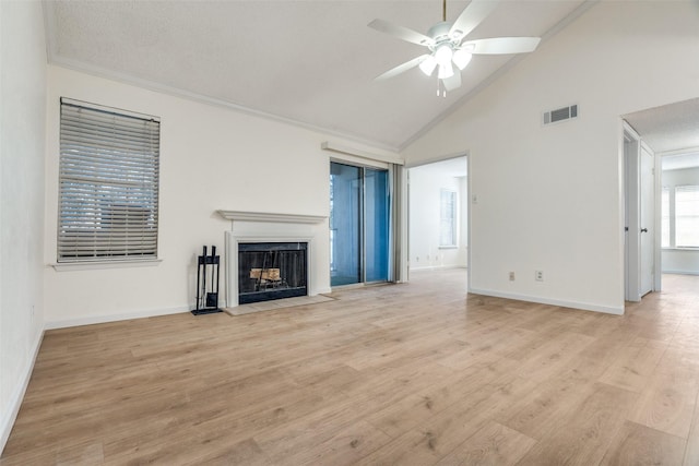 unfurnished living room with visible vents, baseboards, a ceiling fan, a fireplace with flush hearth, and light wood-style floors