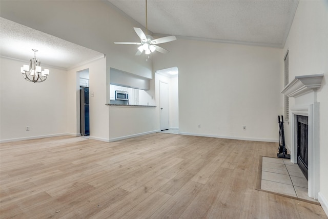 unfurnished living room featuring crown molding, a fireplace, light wood-style flooring, a textured ceiling, and ceiling fan with notable chandelier