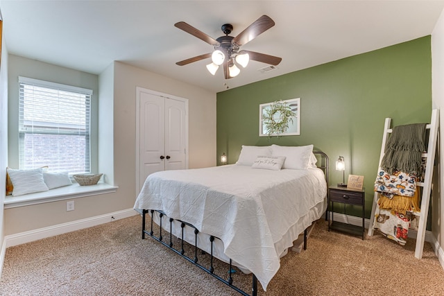 bedroom featuring visible vents, baseboards, a ceiling fan, carpet flooring, and a closet