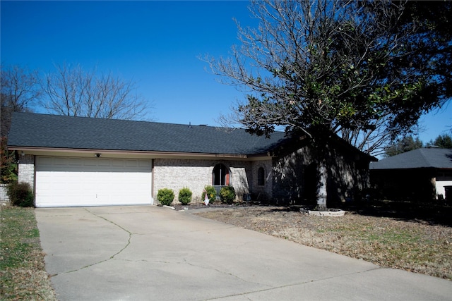 view of front facade with brick siding, driveway, an attached garage, and roof with shingles