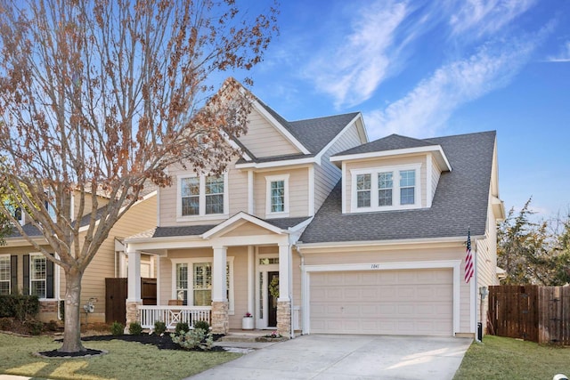 craftsman house with driveway, a garage, a shingled roof, covered porch, and fence