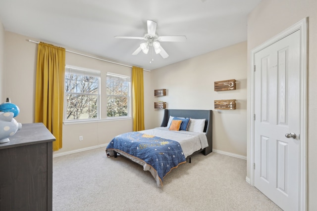 bedroom featuring a ceiling fan, light carpet, and baseboards