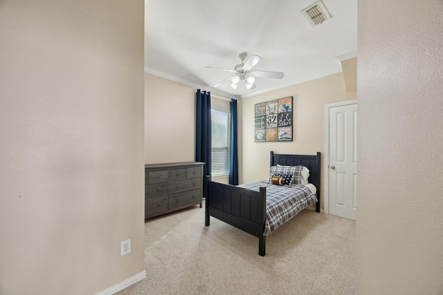 bedroom featuring ornamental molding, visible vents, ceiling fan, and light carpet