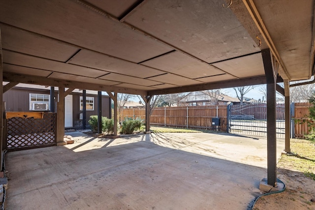 view of patio with a carport, a gate, and fence