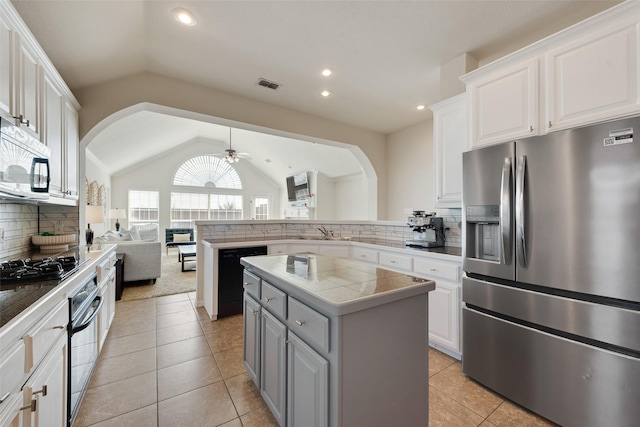 kitchen with a center island, open floor plan, white cabinetry, and black appliances