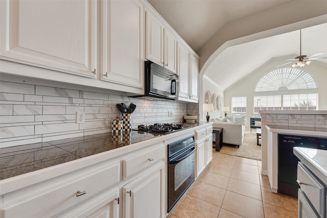 kitchen with lofted ceiling, black appliances, white cabinetry, and open floor plan