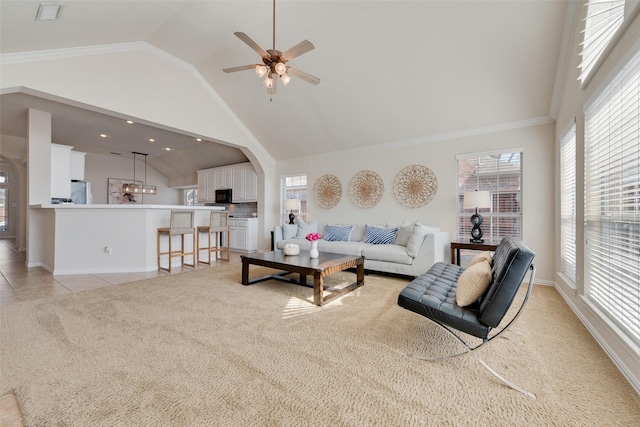 living room featuring light tile patterned floors, high vaulted ceiling, plenty of natural light, and light colored carpet