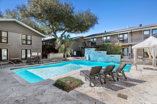 10211 Regal Oaks Dr Unit 121, Dallas, TX 75230 - community pool featuring french doors and a patio area