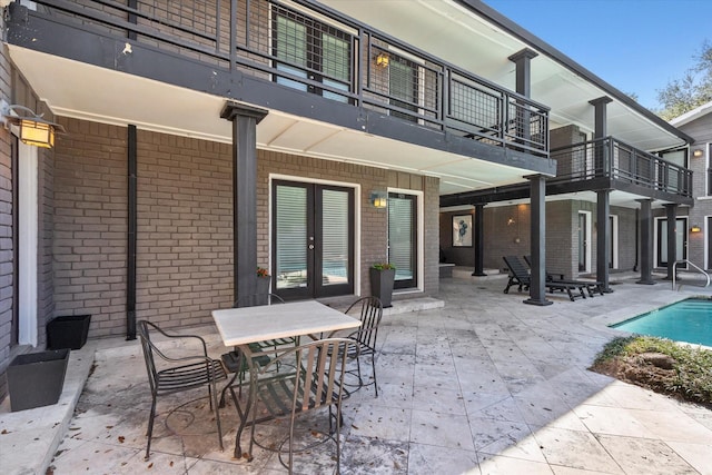 10211 Regal Oaks Dr Unit 121, Dallas, TX 75230 - view of patio / terrace with french doors, an outdoor pool, and outdoor dining area