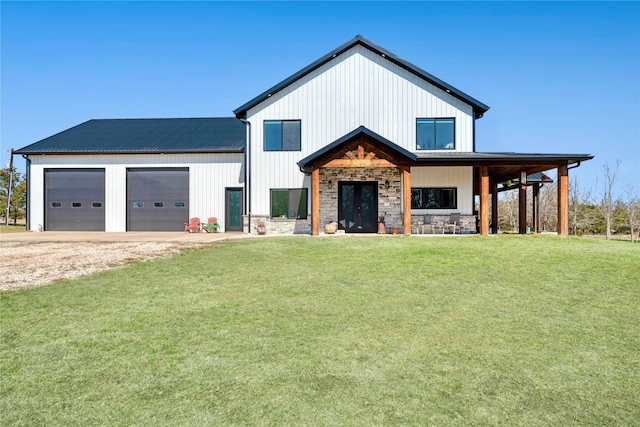 modern farmhouse style home featuring metal roof, an attached garage, dirt driveway, stone siding, and a front yard