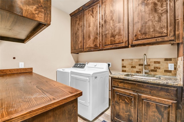 laundry area with washer and dryer, cabinet space, and a sink