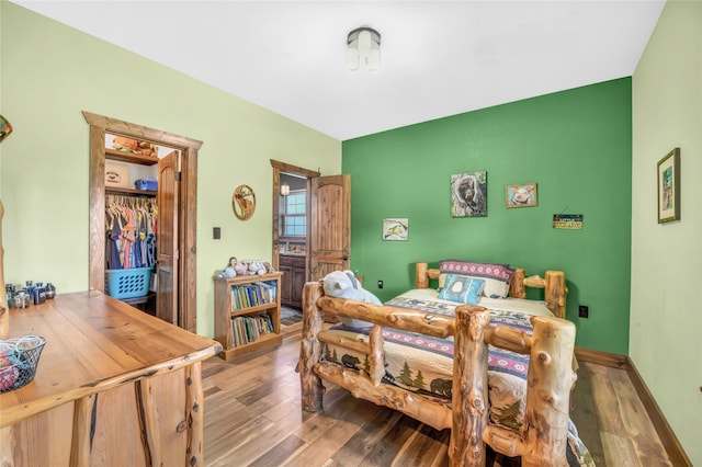 bedroom featuring light wood-type flooring and baseboards