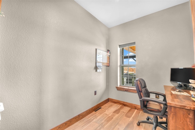 home office featuring visible vents, baseboards, and wood finished floors