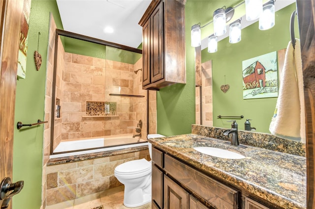 full bathroom with toilet, tiled shower / bath combo, and vanity