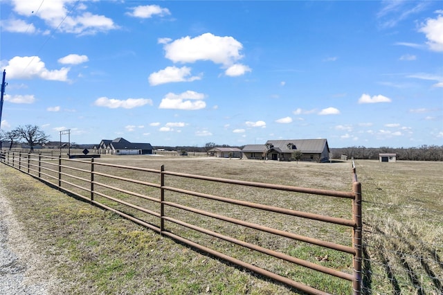 view of gate featuring a rural view and fence