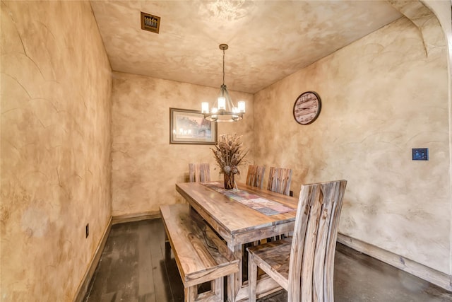 dining room with baseboards, visible vents, a chandelier, and dark wood-type flooring