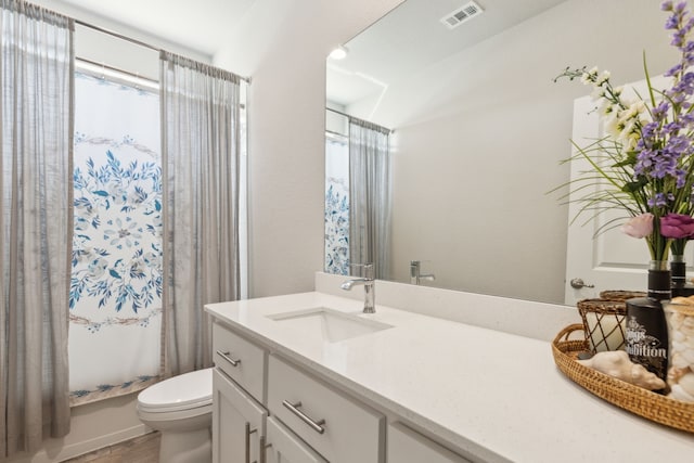 full bathroom with toilet, vanity, shower / bath combo with shower curtain, and visible vents