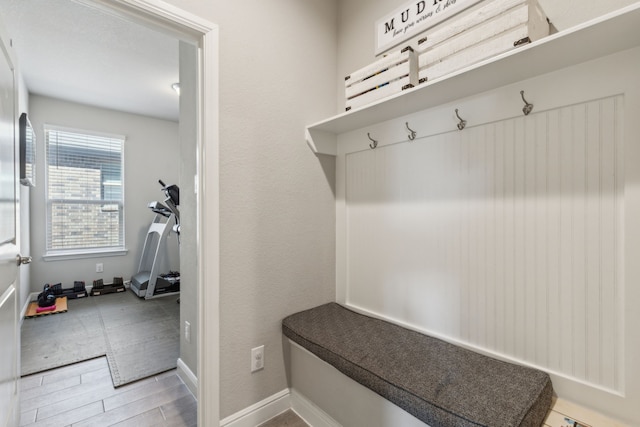 mudroom with wood finished floors and baseboards