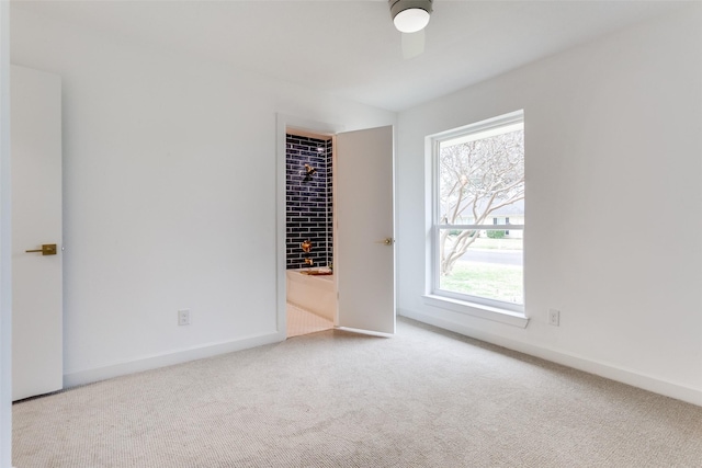 unfurnished bedroom featuring carpet, a ceiling fan, and baseboards